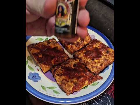 Rocky's hot sauce being poured on pizza