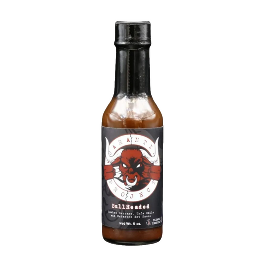 Hot sauce bottle with a black label featuring a red and white design on a white background