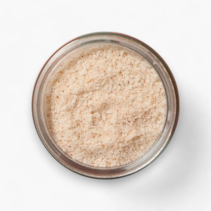 Jar of beige powder on a white background