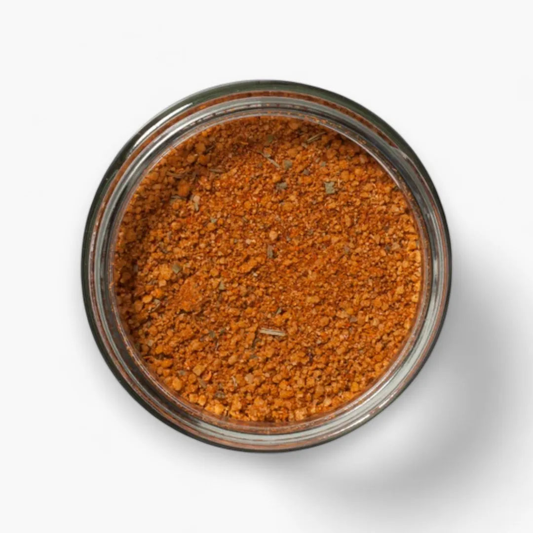 Spice blend in a glass jar on a white background