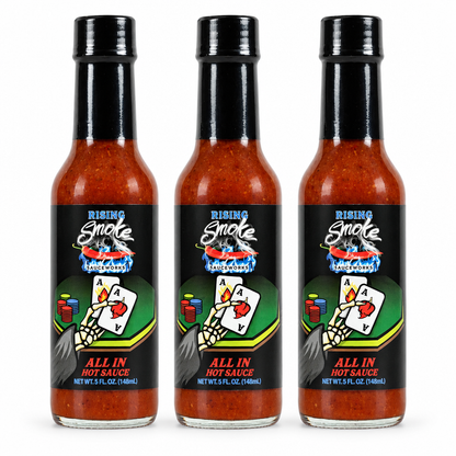 Three bottles of Rising Smoke All In hot sauce